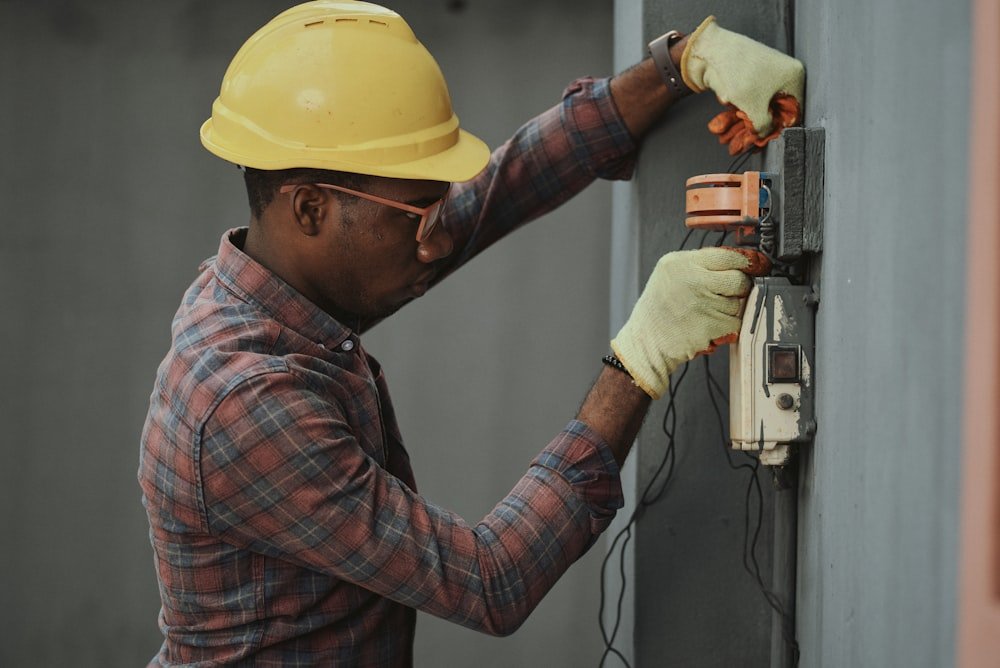 Tenax Enterprise electrician installing a panel connection on site